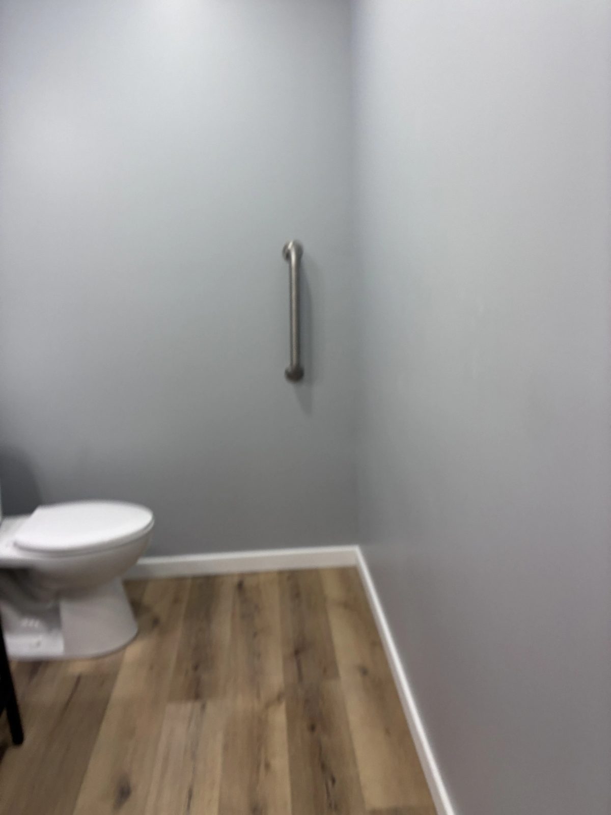 Finished bathroom remodel with safety grab bar