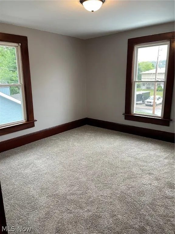 Finished bedroom remodel with new carpet and windows
