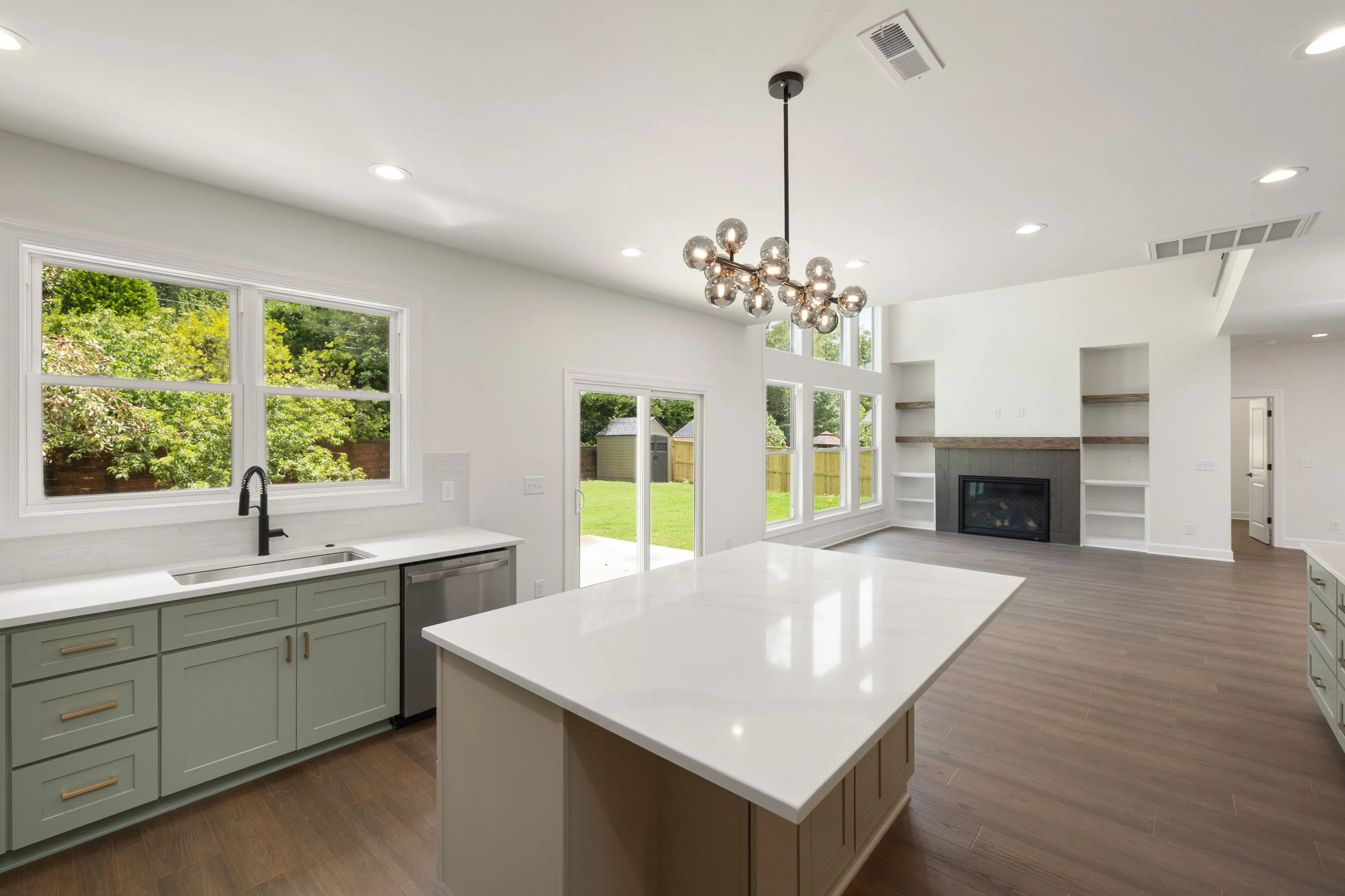 Finished kitchen remodel with green cabinets